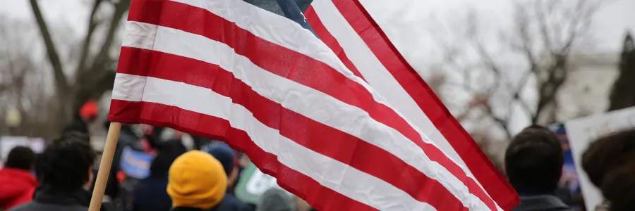 A worker holding an American flag